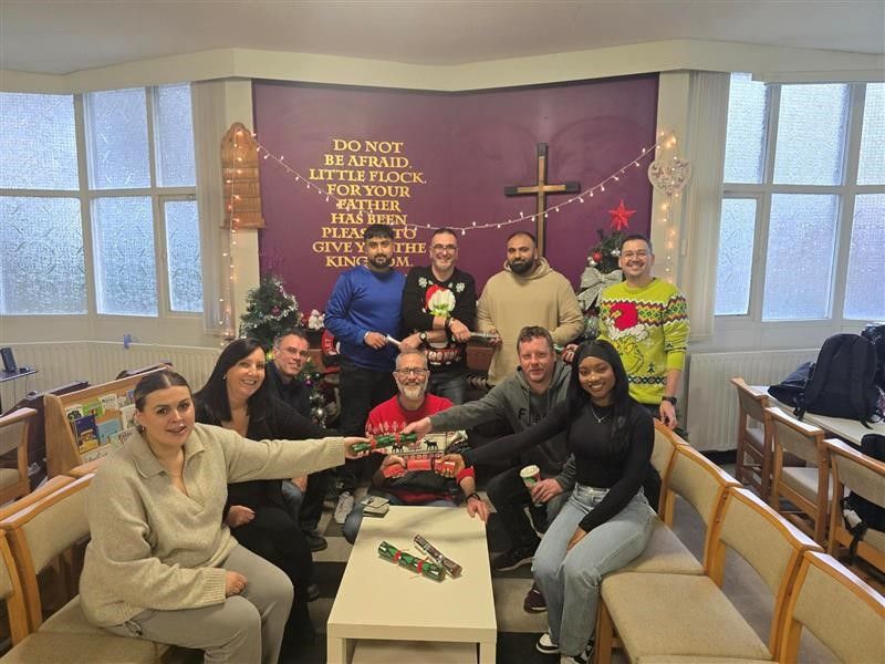 Avove's Business Technology Group team in festive jumpers, pulling crackers