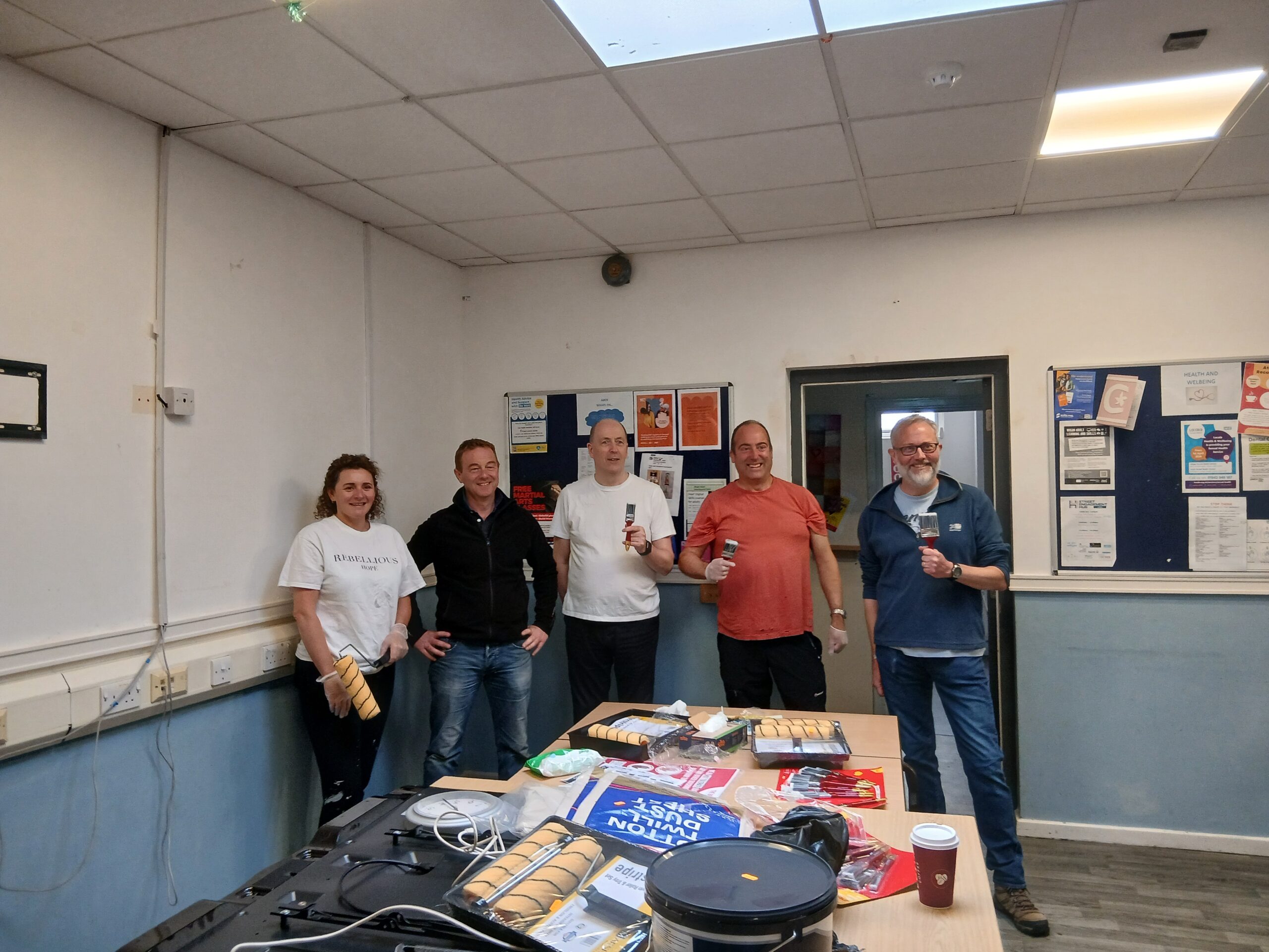 The Avove Executive Leadership Team decorating a local shelter for The Brick.